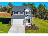 Two-story house with gray siding, white garage door, and landscaped yard at 141 Beacon Hill Rd # 13, Lillington, NC 27546