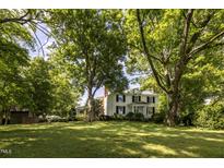 White farmhouse with lush green landscape at 6720 Mebane Oaks Rd, Mebane, NC 27302