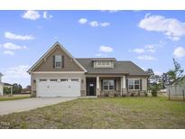 Two-story house with a neutral color scheme and a two-car garage at 71 Hillwood Dr, Sanford, NC 27332