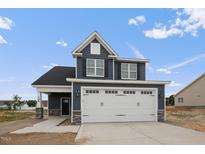 Two-story house with gray siding, white trim, and a two-car garage at 109 Hillwood Dr, Sanford, NC 27332