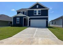 Two-story navy blue house with white garage at 352 Chestnut Oak Ln, Lillington, NC 27546