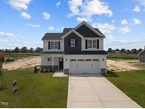 Two-story house with a two car garage and front yard at 114 Hillwood Dr, Sanford, NC 27332