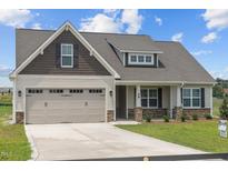 House exterior with neutral colors and a two-car garage at 58 Hillwood Dr, Sanford, NC 27332