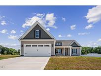 Two-story house with a two-car garage and landscaping at 50 Oleander Ln, Sanford, NC 27332