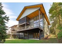 Modern home with a screened porch, deck, and backyard at 1435 Duplin Rd, Raleigh, NC 27607