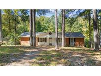 Brick ranch house with white accents and a large yard at 104 Lake Dr, Clayton, NC 27520