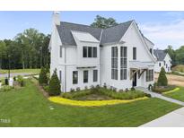 Charming white two-story home with a landscaped yard and a welcoming walkway at 3401 Makers Cir, Raleigh, NC 27612