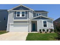 Two story home with gray siding and teal door at 323 Chestnut Oak Ln, Lillington, NC 27546