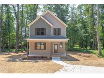 Two-story house with light brown siding and dark brown accents at 204 Cardinal Ct, Oxford, NC 27565