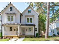 Two-story home with white siding, metal roof, and front porch at 5061 Lundy Dr # 102, Raleigh, NC 27606