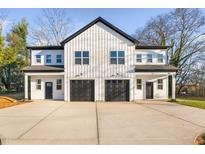 Two-unit modern farmhouse with attached garages and concrete driveway at 331 Roxboro St, Haw River, NC 27258