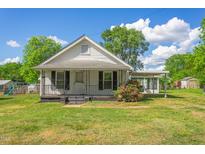 White house with a green lawn, showcasing classic architecture at 317 Quintas Ave, Burlington, NC 27215