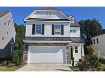 Two-story house with white siding, black windows and a two car garage at 3455 Piedmont Dr, Raleigh, NC 27604