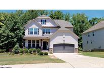 Two-story home with gray siding and a two-car garage at 104 Abbeville Ln, Holly Springs, NC 27540