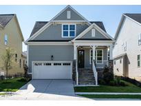 Gray house with white garage door and stone accents at 1717 Grassy Falls Ln, Wendell, NC 27591