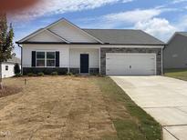 Newly built ranch home with white siding and stone accents at 122 Vega Loop # 61, Sanford, NC 27330