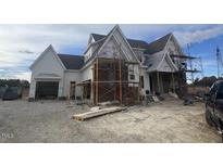 Two-story craftsman style home with white siding and a detached garage at 4909 Hidden Pasture Way, Zebulon, NC 27597