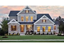 Stunning two-story home with stone accents and a manicured lawn at 4213 Burlington Mills Rd, Wake Forest, NC 27587