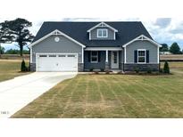 Two-story home with gray siding, white garage door, and stone accents at 246 Gin Branch Road, Wendell, NC 27591