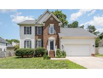 Two story brick and white sided home with attached garage at 2205 Moon Water Way, Garner, NC 27529