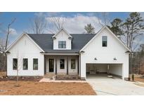 Modern farmhouse exterior with white siding and dark accents at 1690 Terry Rd, Durham, NC 27712