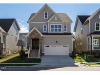 Two-story home with a neutral color scheme and two-car garage at 1719 Grassy Falls Ln, Wendell, NC 27591