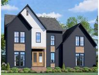 Two-story home with dark siding, white accents, and a wooden front door at 8317 Dolce Dr, Wake Forest, NC 27587