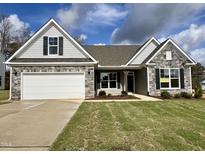 Two-story craftsman home with stone accents and a three car garage at 52 Gander Dr, Benson, NC 27504