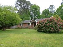 Brick ranch house with a large front yard and landscaping at 511 Normandy St, Cary, NC 27511
