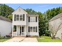 Exterior view of 2-story home with white siding at 4425 Woodlawn Dr, Raleigh, NC 27616