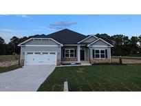 New construction home features a gray exterior, white garage door, and stone accents at 680 Sweet Potato Lane # 34, Nashville, NC 27856