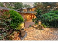 Brick walkway to inviting front entrance of charming home with stone accents at 643 Brookview Dr, Chapel Hill, NC 27514