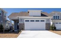 Modern craftsman style home with stone accents and a two-car garage at 231 Village Walk Dr, Clayton, NC 27527