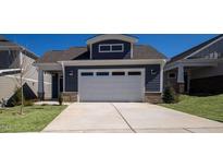 Two-story home with gray siding and a white garage door at 154 Swain St, Clayton, NC 27527