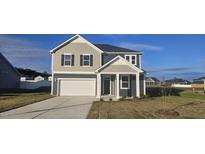 Two-story home with gray siding, white garage door, and landscaping at 466 Saint Clair Dr, Fuquay Varina, NC 27526
