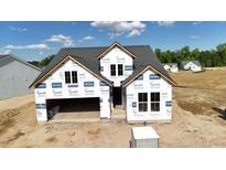 New construction home with gray roof and attached garage at 2048 Abbeyhill Dr, Raleigh, NC 27610