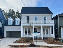 Two-story house with gray siding, white trim, and a multi-paneled front door at 809 St Charles St, Durham, NC 27713