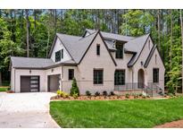 Two-story house with a white brick facade, gray roof and a attached garage at 503 Damascus Church Rd, Chapel Hill, NC 27516