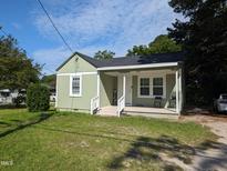 Charming light green house with a covered porch at 1508 Burton St, Rocky Mount, NC 27803