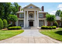 Impressive two-story home with a grand entrance, brick facade, and manicured landscaping at 1820 Oatlands Court Ct, Wake Forest, NC 27587