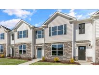Three-unit townhouse building with stone accents at 863 Old Tarboro Rd, Wendell, NC 27591