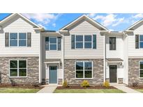 Two story townhome with stone accents and a teal door at 859 Old Tarboro Rd, Wendell, NC 27591