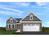 Two-story home with gray siding, stone accents, and a two-car garage at 136 Coble Farms Pl, Fuquay Varina, NC 27526