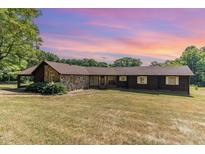 Ranch style home with stone and wood siding at 8450 Perry Rd, Graham, NC 27253