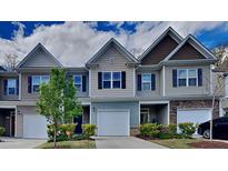 Three-unit townhouse exterior with two-car garage at 3635 Water Mist Ln, Raleigh, NC 27604