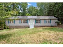 Single-story home with solar panels and landscaped yard at 1510 Logan St, Durham, NC 27704