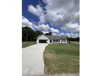 Ranch-style home with attached garage and landscaped lawn at 184 Grace Ridge Ct, Benson, NC 27504