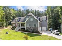 Gray two-story house with stone accents, attached garage, and large yard at 13671 Burgess Rd, Middlesex, NC 27557