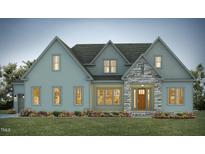 Two-story craftsman style home with light blue siding and stone accents at 111 Gaines Trail, Pittsboro, NC 27312