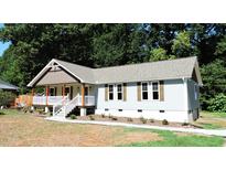 Charming one-story home with a covered porch and landscaped yard at 513 N Carr St, Mebane, NC 27302